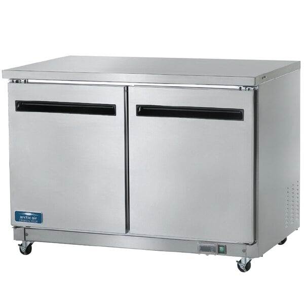Two Arctic Air stainless steel undercounter refrigerators with two doors.