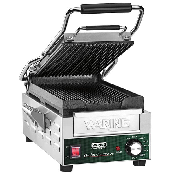 A Waring Compresso Panini Grill with grooved plates and a lid.