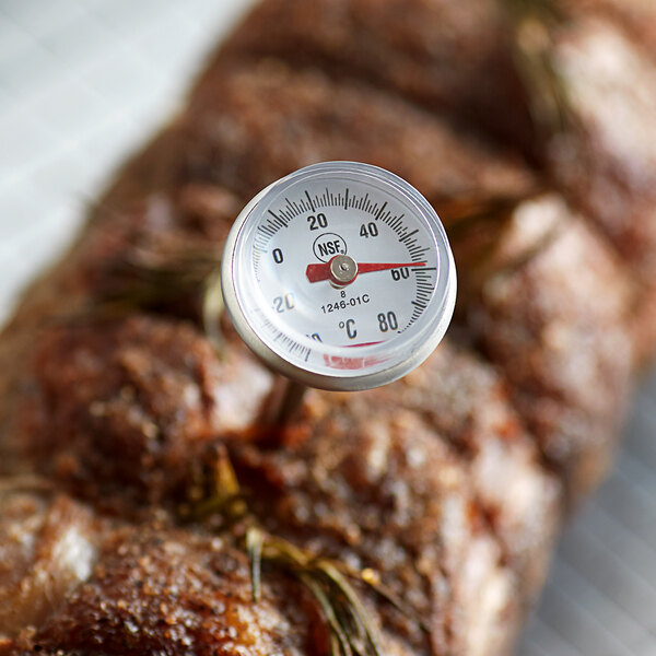 A Cooper-Atkins pocket probe thermometer taking the temperature of a piece of meat.