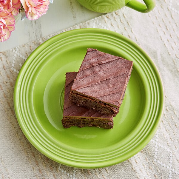 A plate of chocolate brownies on an Acopa Capri green stoneware plate.