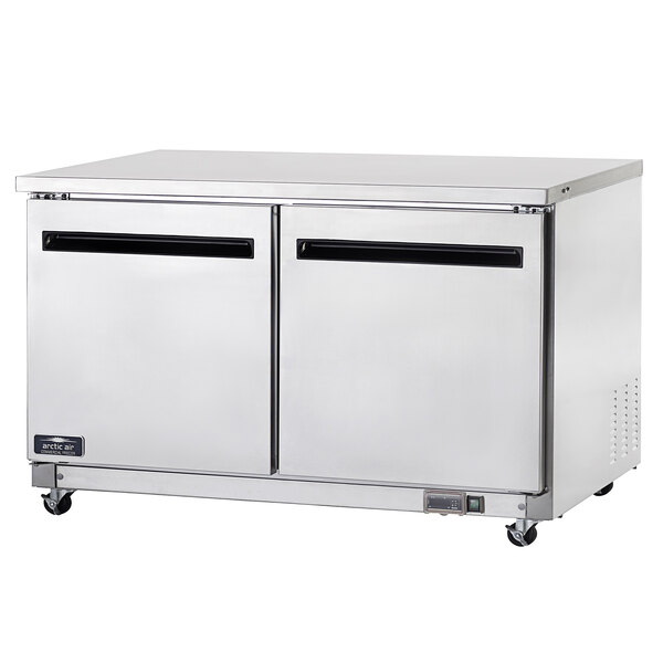 A stainless steel Arctic Air undercounter freezer with two doors.