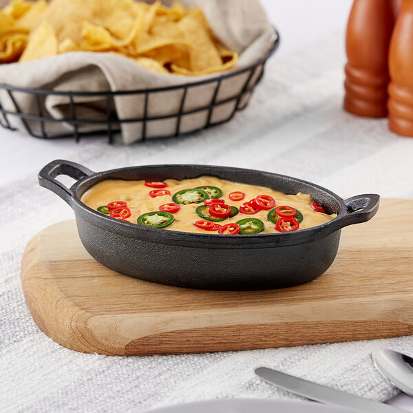 A Valor pre-seasoned cast iron casserole dish with food and jalapenos in it.