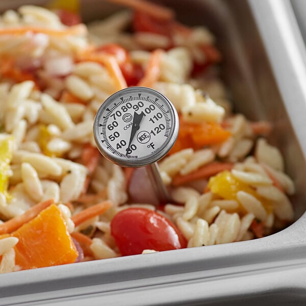 A Comark pocket probe thermometer inserted into a bowl of food.