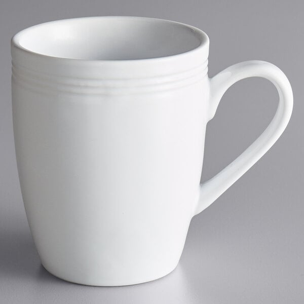 A white Acopa stoneware mug with a handle.