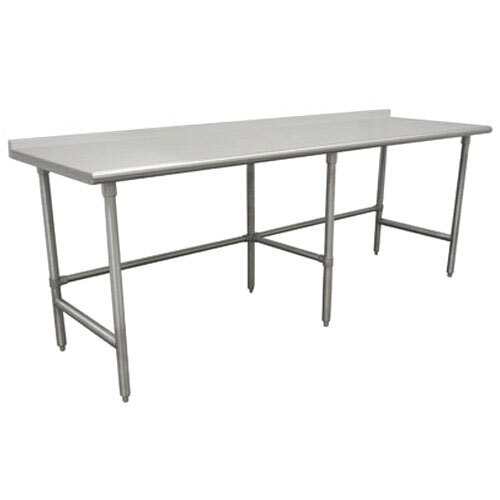 A stainless steel Advance Tabco work table with a long white top and backsplash on an open base with legs.