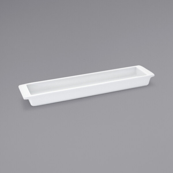 A Front of the House white rectangular porcelain server on a gray surface.