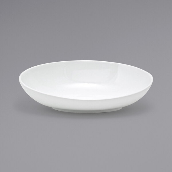 A Front of the House white porcelain oval bowl on a gray surface.