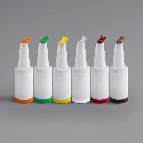 A group of white Tablecraft PourMaster plastic bottles with assorted color caps.