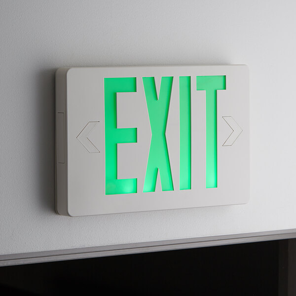 A Lavex green LED exit sign with a green lit up sign on a wall.