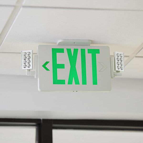A Lavex green LED exit sign with green text and an arrow hanging from a ceiling.