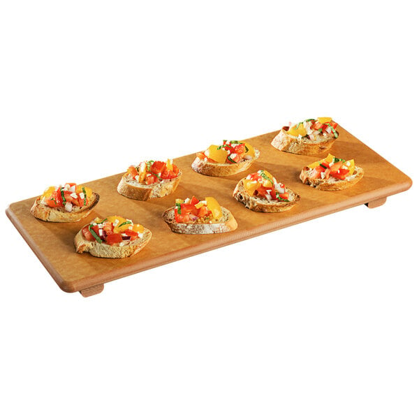 A Tomlinson Richlite wood fiber serving board with food on it.