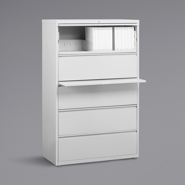 A white Hirsh Industries lateral file cabinet with drawers and roll out binder storage.