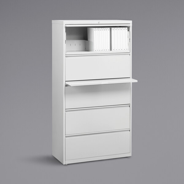 A white Hirsh Industries lateral file cabinet with drawers and a shelf.