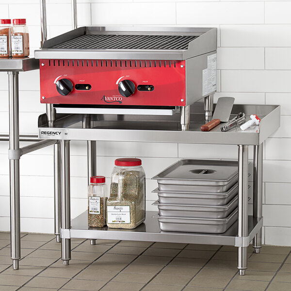A large stainless steel grill on a stainless steel shelf.