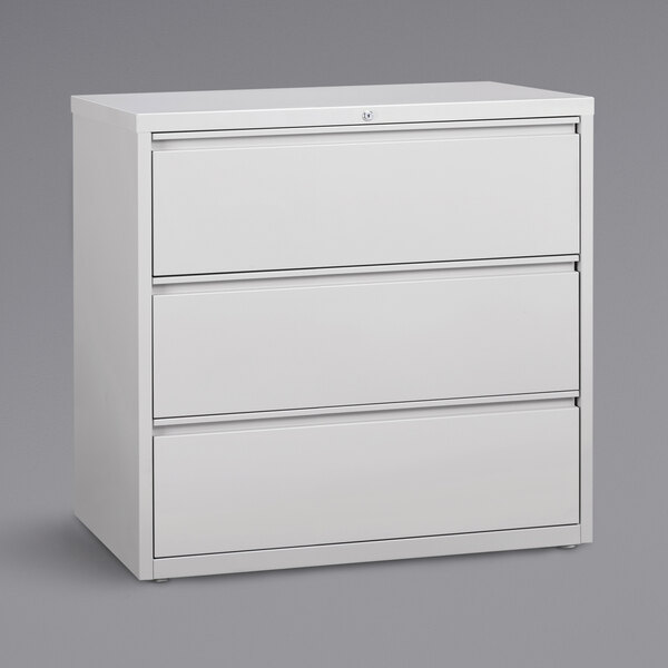 A white Hirsh Industries lateral file cabinet with three drawers.