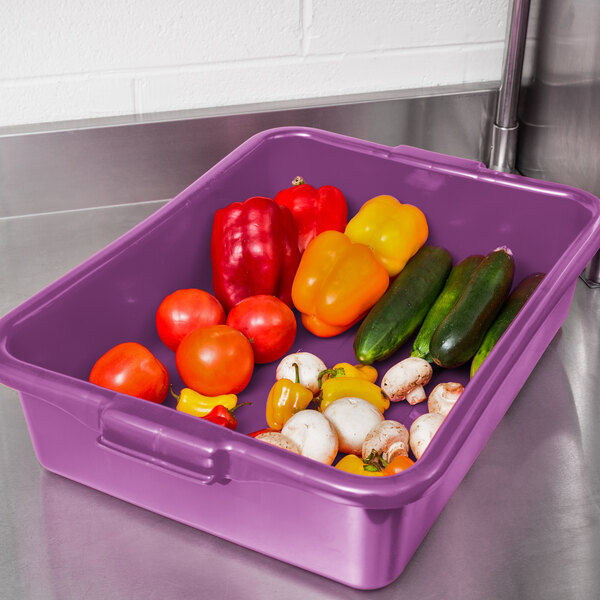 A purple Vollrath Traex food storage container full of vegetables.