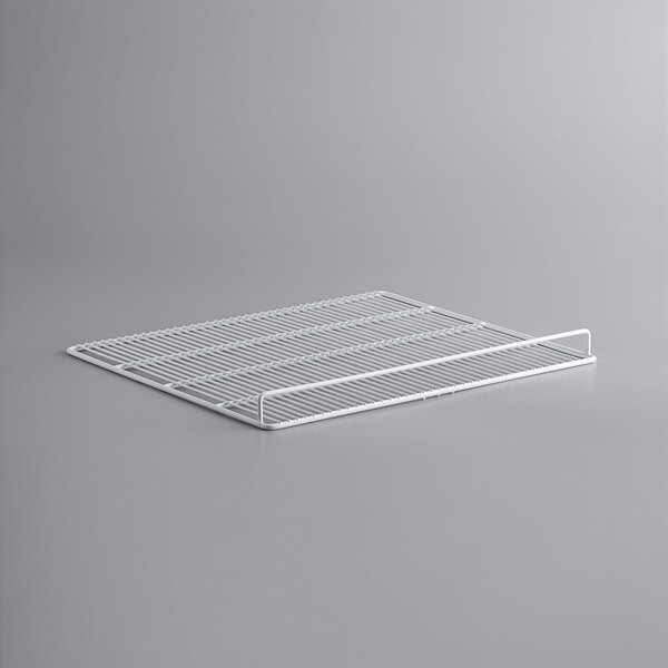 A white wire rack on a gray surface.