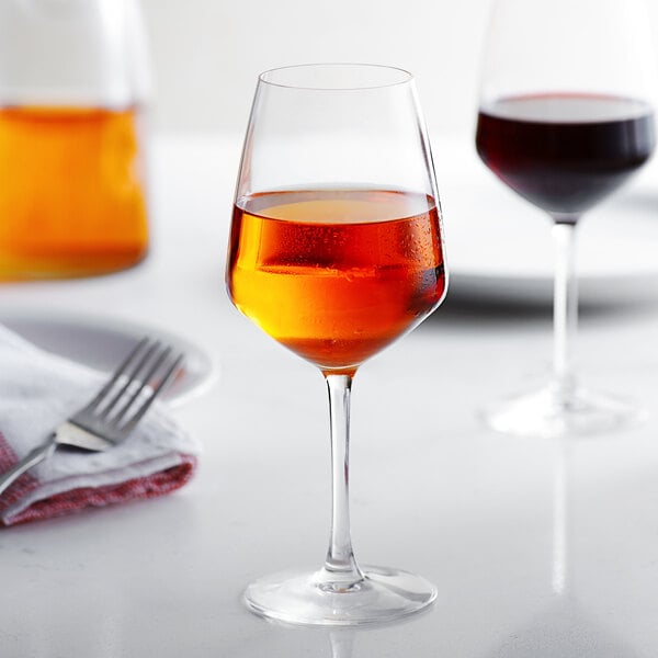 A close up of two Arcoroc wine glasses on a table.