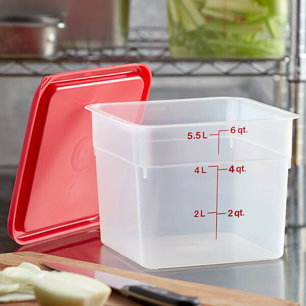 A translucent plastic Cambro food storage container with a red lid.