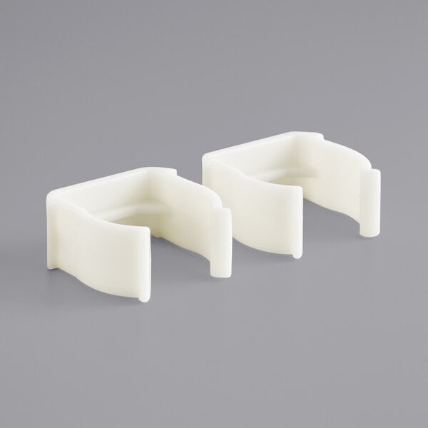 A pair of white plastic clips.
