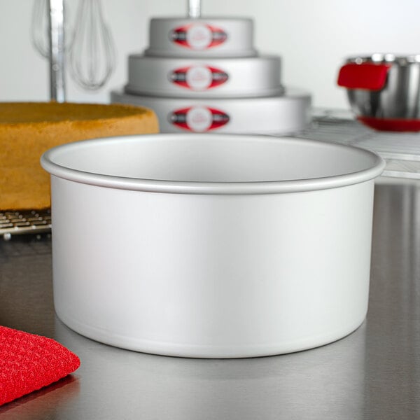 A Fat Daddio's round anodized aluminum cake pan on a counter.