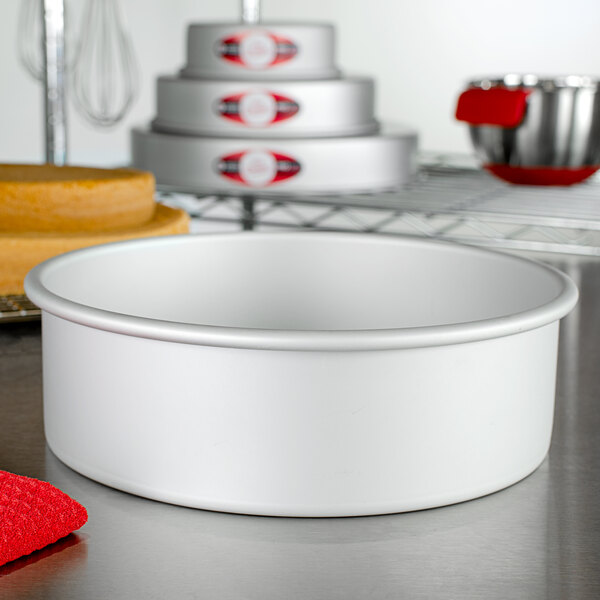 A Fat Daddio's anodized aluminum round cake pan on a counter.