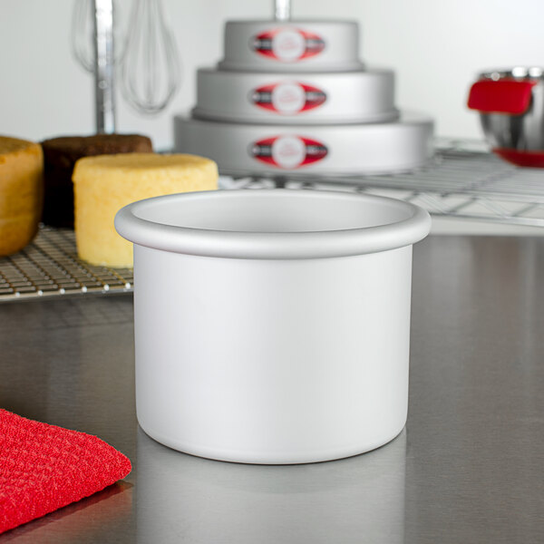 A close-up of a white cylinder, the Fat Daddio's ProSeries round cake pan.