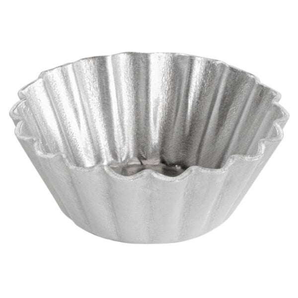 A silver round bowl with wavy edges.