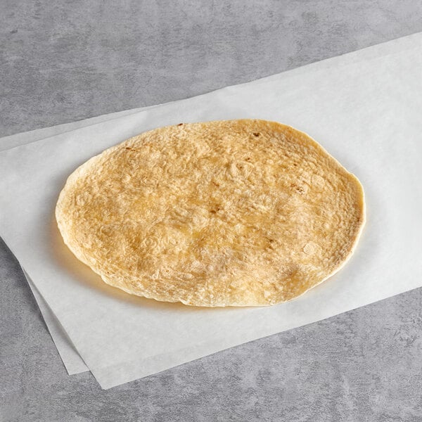 A Father Sam's Bakery sundried tomato tortilla on a white paper.