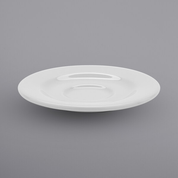A white porcelain saucer with a curved rim.