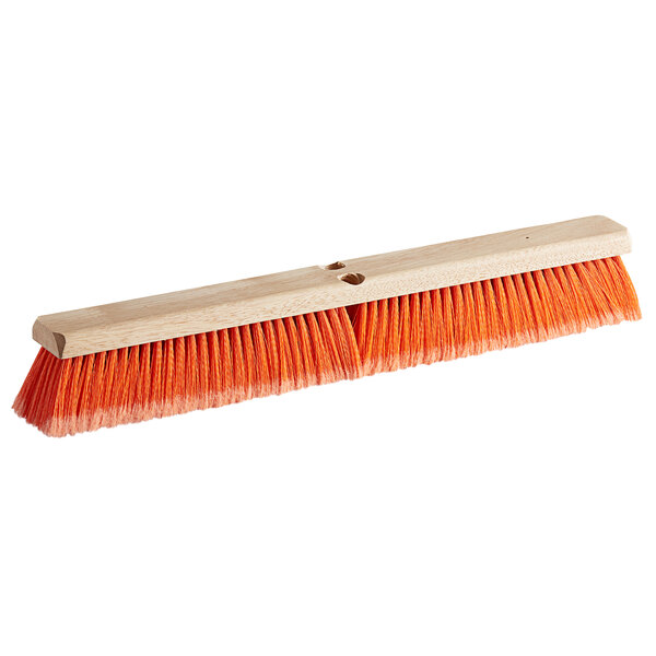 A Carlisle Flo-Pac hardwood push broom head with orange bristles.