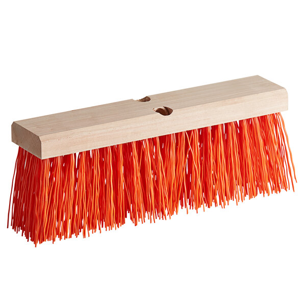 A Carlisle hardwood broom head with orange bristles.