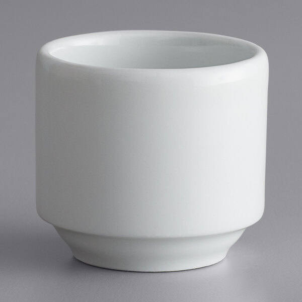 A white Corona by GET Enterprises porcelain ramekin on a gray surface.
