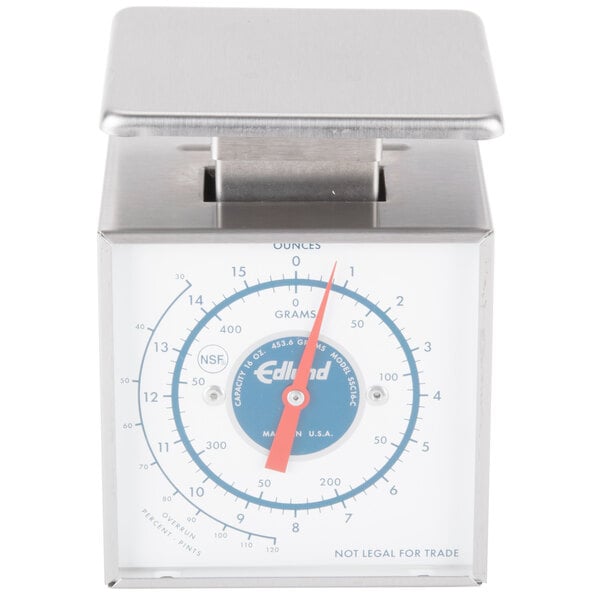 A silver metal Edlund ice cream scale with a blue dial.