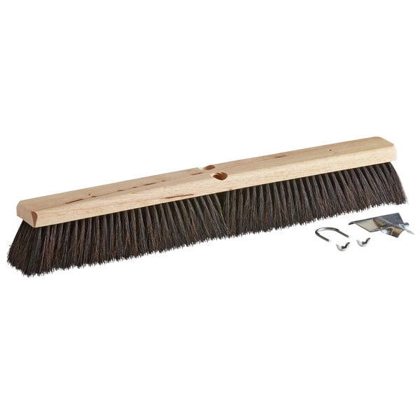 A Carlisle hardwood push broom head with horsehair and tampico bristles and two metal clips.