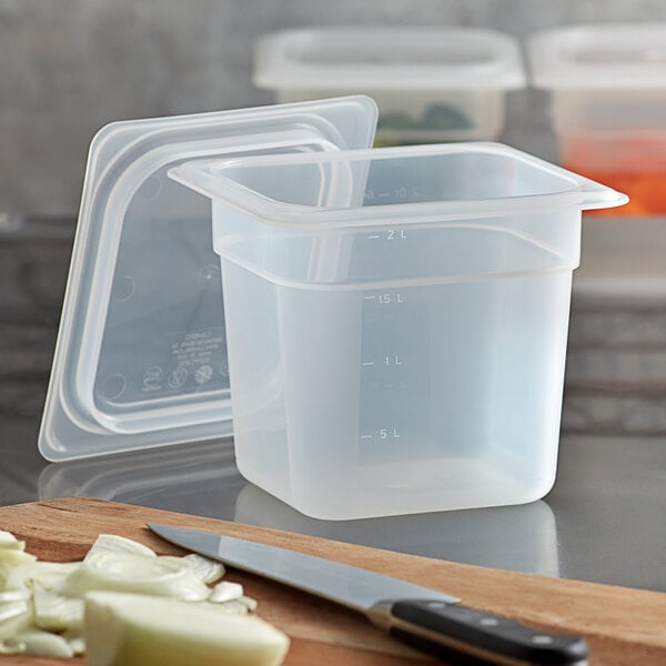 A translucent plastic food pan with lid on a white background.