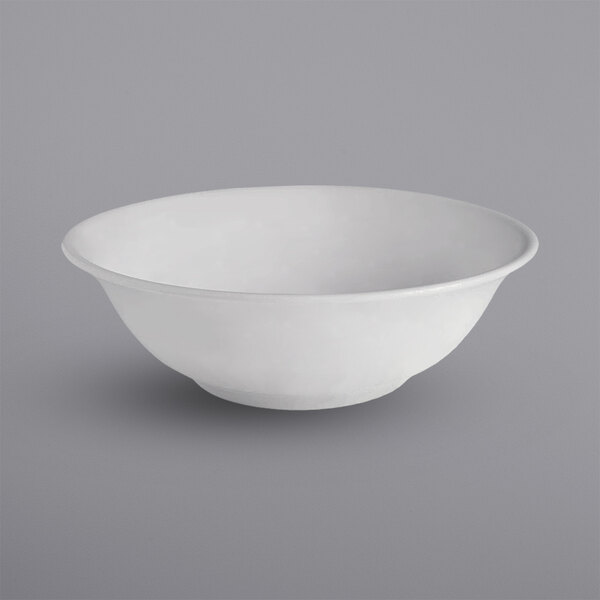 A bright white porcelain salad bowl with a white background.