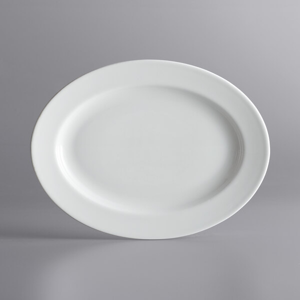 A white porcelain oval platter with a wide rim.