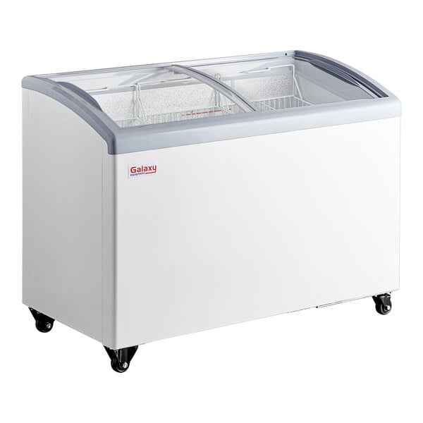 A white Galaxy curved top display freezer on wheels.