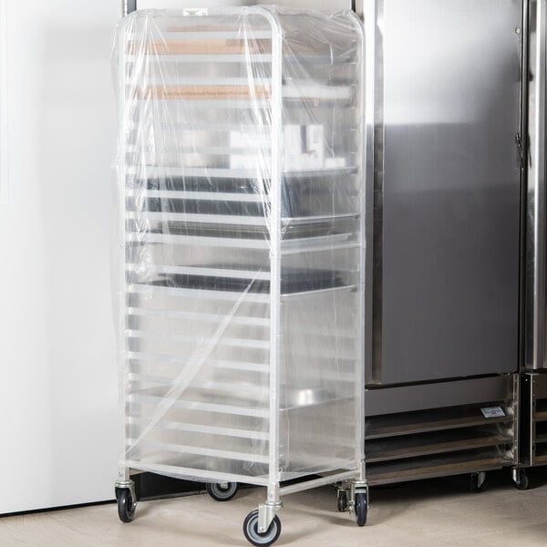 A white plastic disposable bun pan rack cover on a large storage rack.