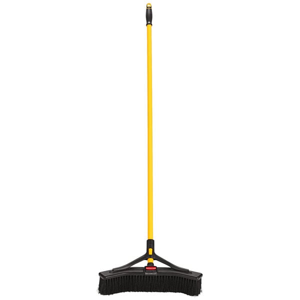 A Rubbermaid commercial push broom with a yellow handle and black bristles.