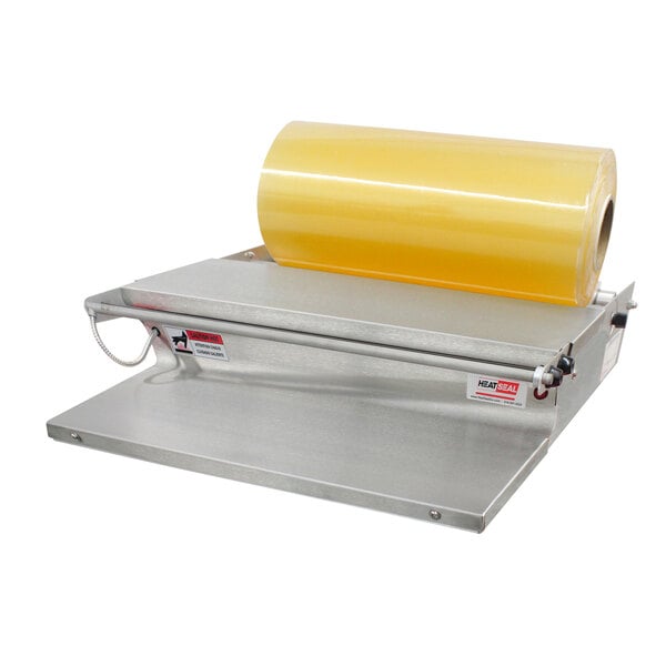A Heat Seal WP-20 B roll film wrapping machine with a yellow roll of plastic on the counter.