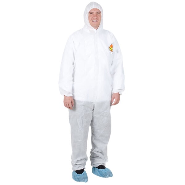 A man wearing a Cordova white disposable polypropylene coverall with a hood.