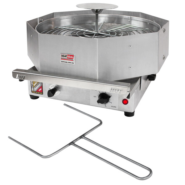 A Heat Seal PC-1318 Pizza and Deli Tray Roll Film Wrapping Machine with a round metal grate.
