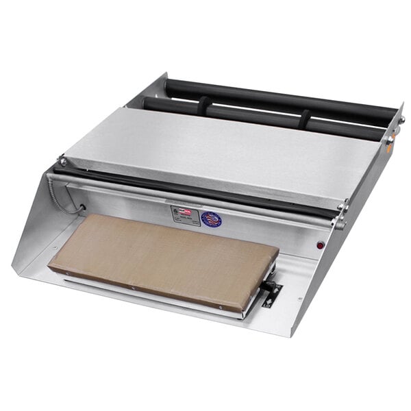 A Heat Seal countertop wrapping machine with a rectangular object on it.
