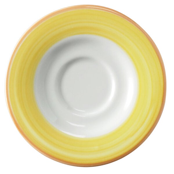 A white porcelain saucer with a yellow and coral rim.