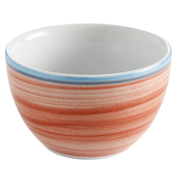 A close up of a coral porcelain bouillon bowl with red and blue stripes.