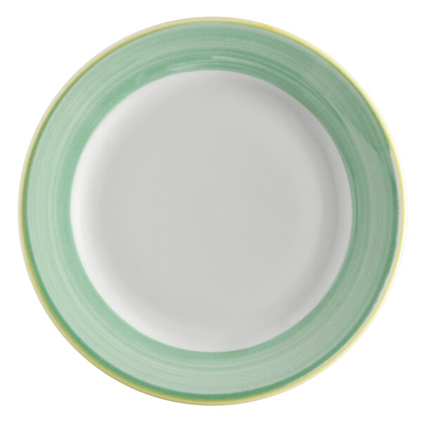 A close-up of a white porcelain plate with a green and yellow rim.