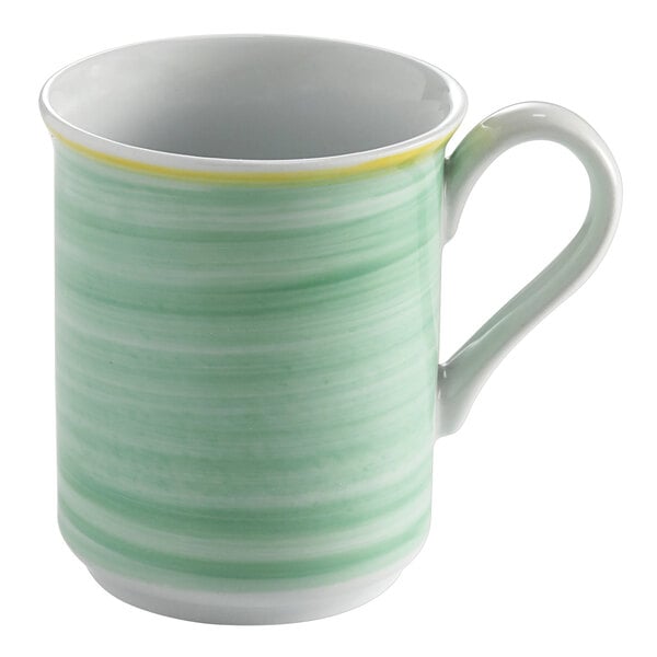 A green mug with a yellow striped rim and handle.