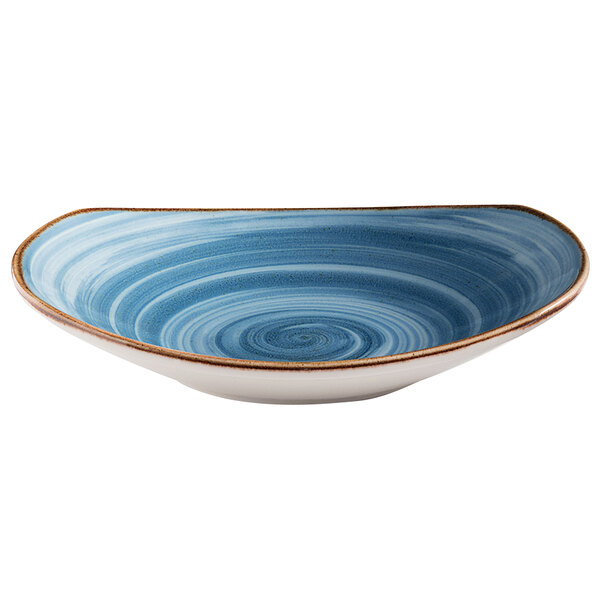 A blue bowl with a white swirl pattern on the table.